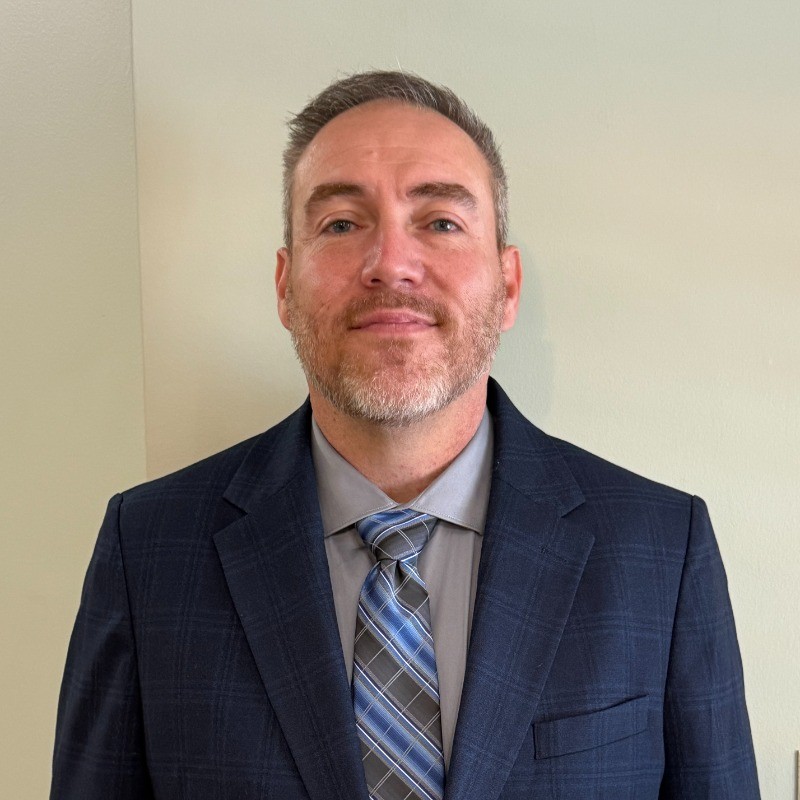 Professional headshot of Dr. Adam Yates.